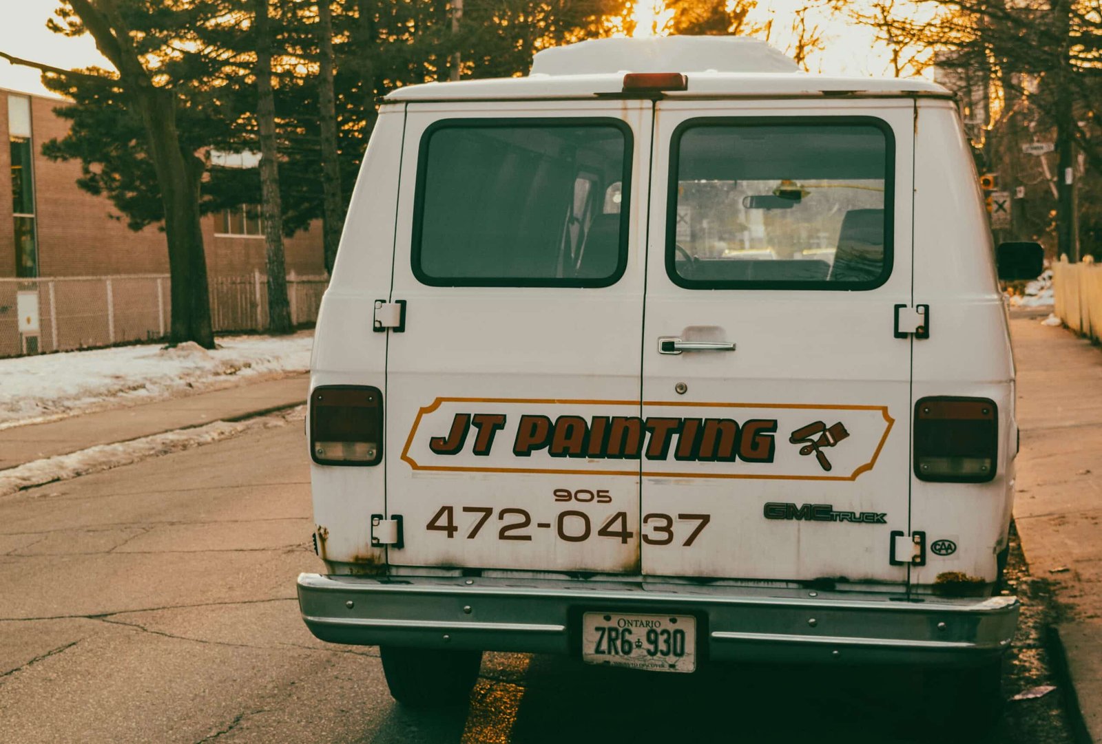 Contractor work van with the real company phone number painted on the back, the number a Google Business Profile photo scam tries to replace