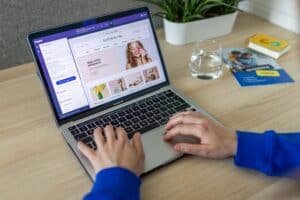 Business owner building a website on a laptop using an AI website builder editor